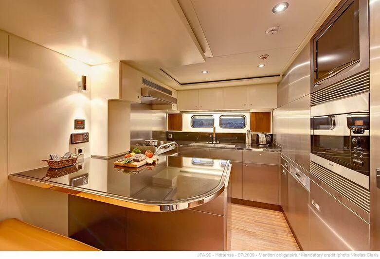 a kitchen with a large island aboard HORTENSE Yacht for Sale