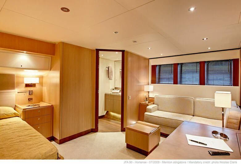 a room with a couch and a table aboard HORTENSE Yacht for Sale