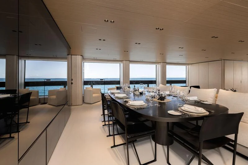 a large room with a table and chairs aboard VIRTUOSITY Yacht for Sale
