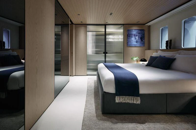 a room with a bed and a window aboard VIRTUOSITY Yacht for Sale