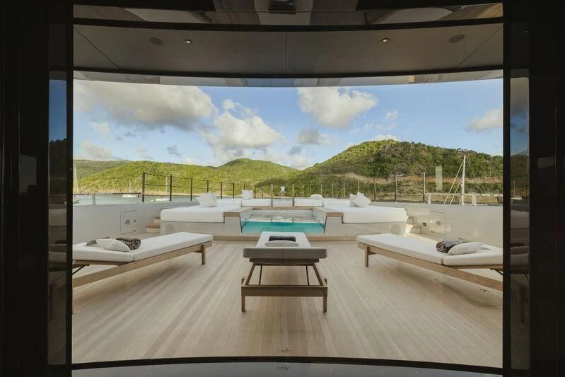 a room with a pool table and a view of the water aboard VIRTUOSITY Yacht for Sale