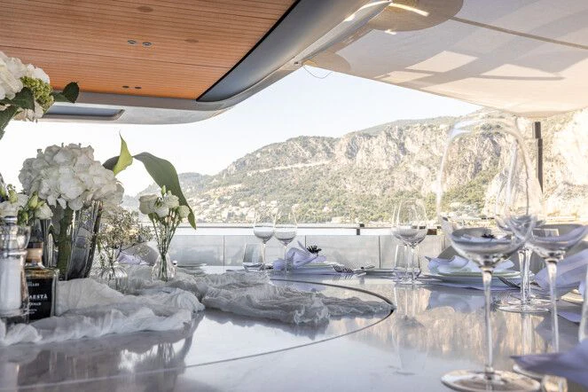 a table with wine glasses aboard VIRTUOSITY Yacht for Sale