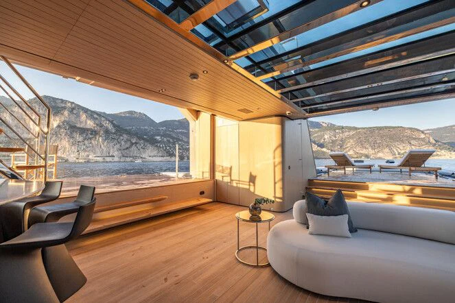 a room with a view of mountains and water aboard VIRTUOSITY Yacht for Sale