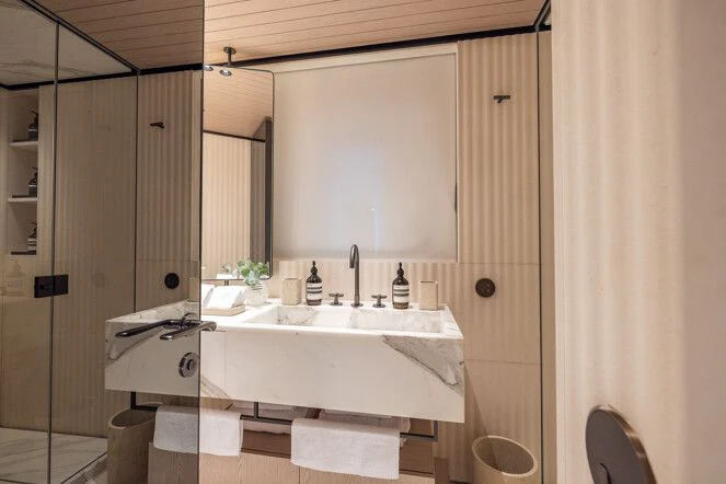 a bathroom with a sink and mirror aboard VIRTUOSITY Yacht for Sale