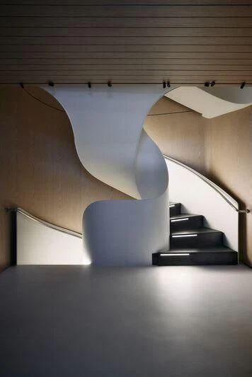 a room with a chair and a staircase aboard VIRTUOSITY Yacht for Sale