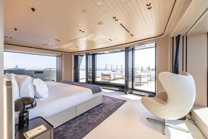 a room with a bed and a chair aboard VIRTUOSITY Yacht for Sale
