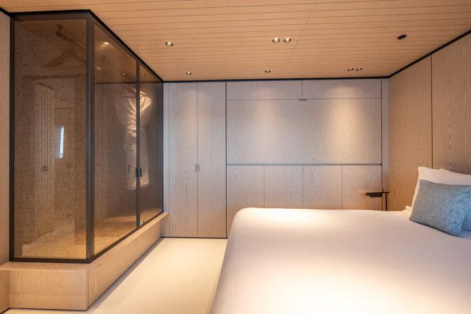 a room with a bed and a closet aboard VIRTUOSITY Yacht for Sale