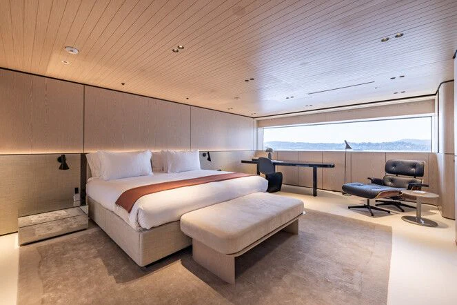 a room with a bed and a table aboard VIRTUOSITY Yacht for Sale