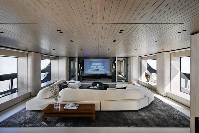 a living room with a large screen aboard VIRTUOSITY Yacht for Sale