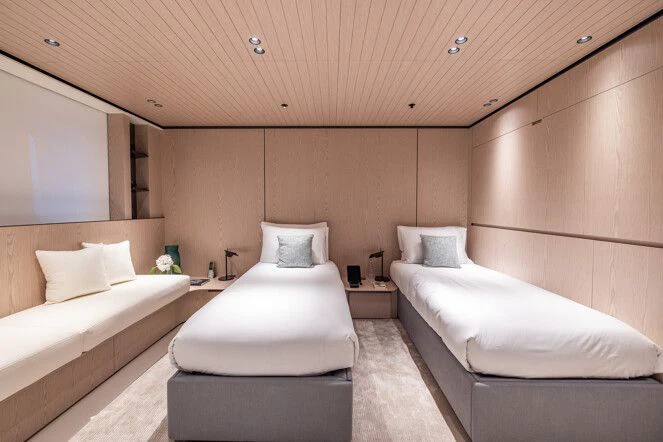 a room with a couple of beds aboard VIRTUOSITY Yacht for Sale
