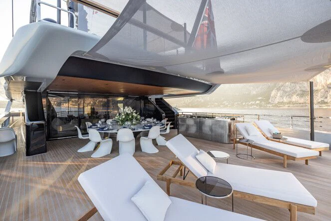 a large room with tables and chairs aboard VIRTUOSITY Yacht for Sale