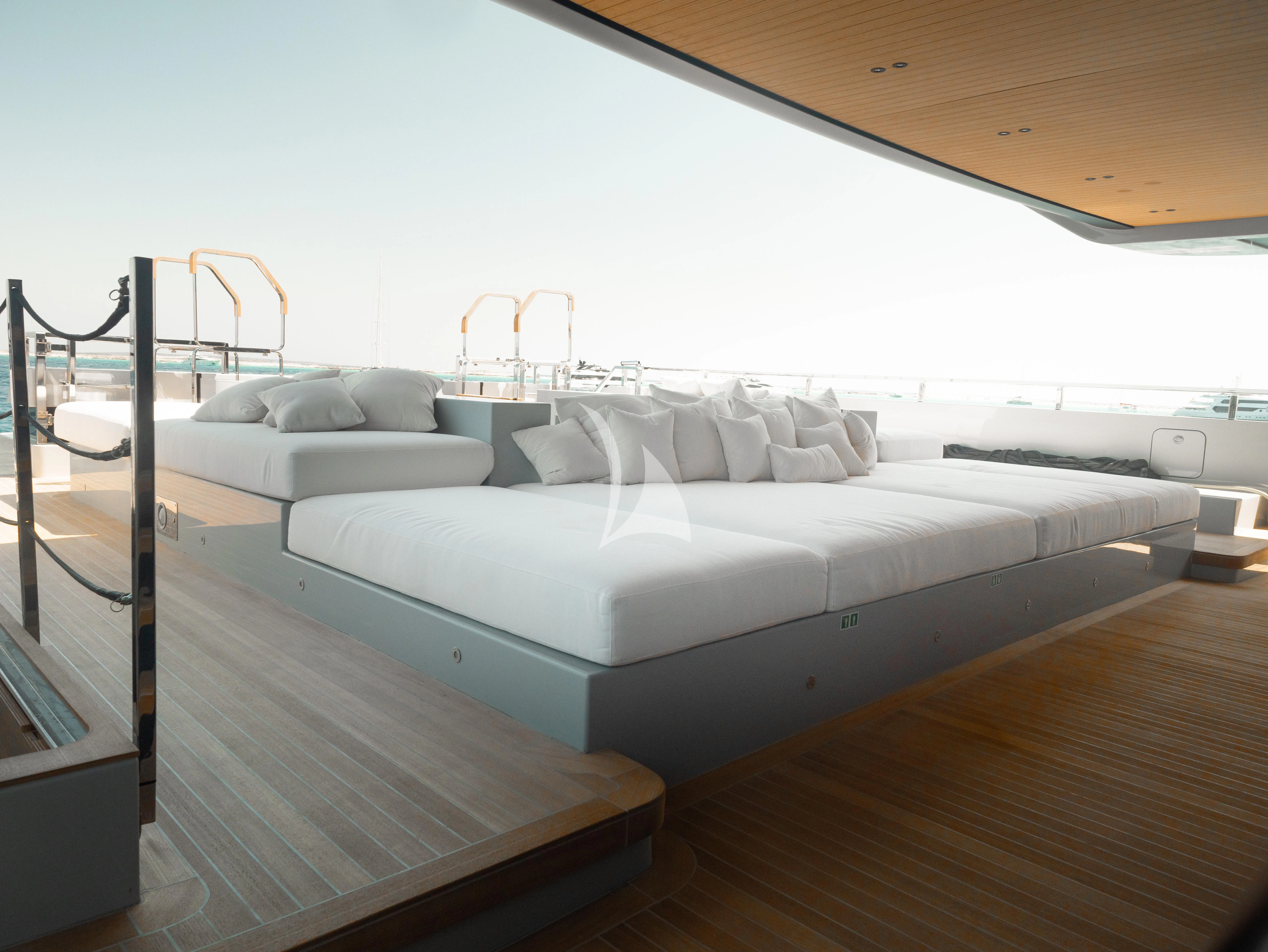 a room with a bed and a chair aboard VIRTUOSITY Yacht for Sale