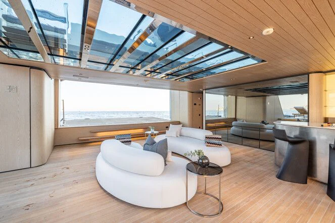 a large living room with a large window aboard VIRTUOSITY Yacht for Sale