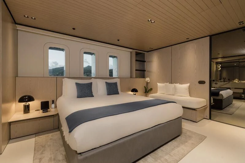 a room with a bed and a mirror aboard VIRTUOSITY Yacht for Sale