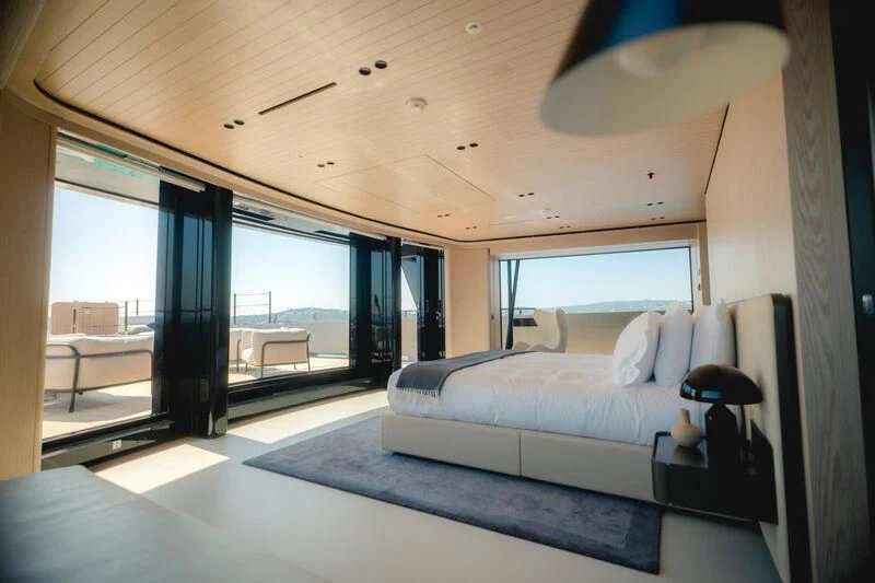a bedroom with a large bed aboard VIRTUOSITY Yacht for Sale