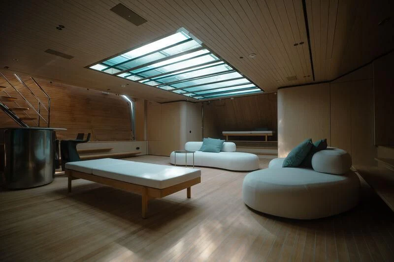 a room with a couch and a table aboard VIRTUOSITY Yacht for Sale