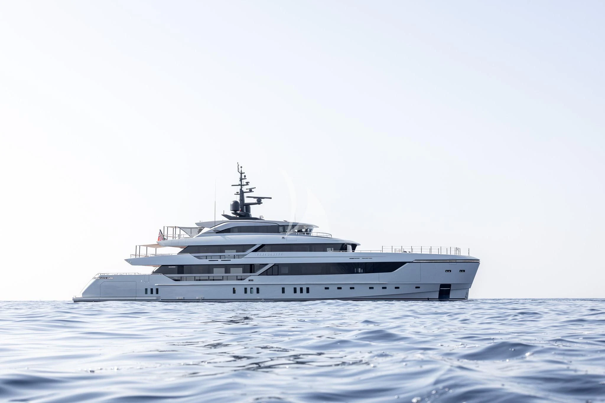 a white yacht in the water aboard VIRTUOSITY Yacht for Sale