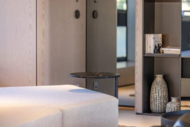 a room with a table and a shelf with books on it aboard VIRTUOSITY Yacht for Sale