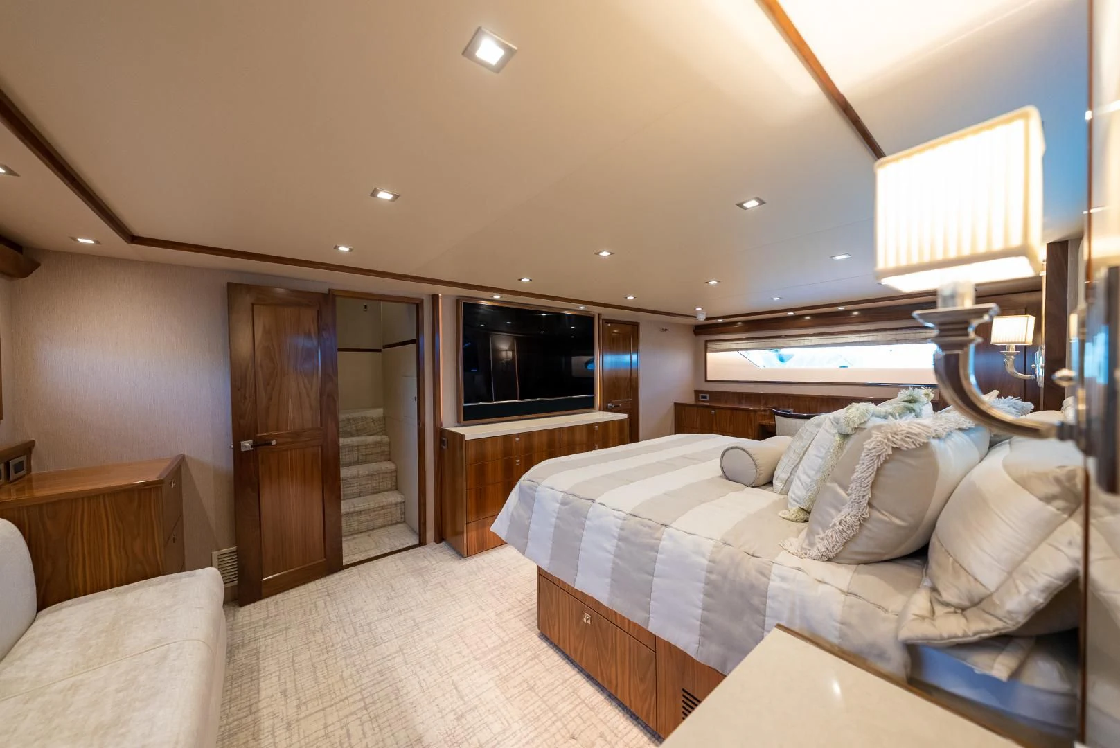 a bedroom with a bed and a television aboard SIR' REEL Yacht for Sale