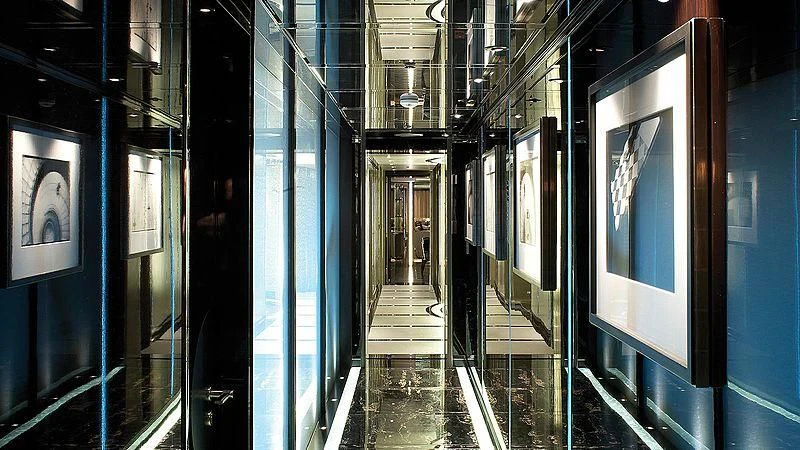 a hallway with blue lights aboard SEALION Yacht for Sale