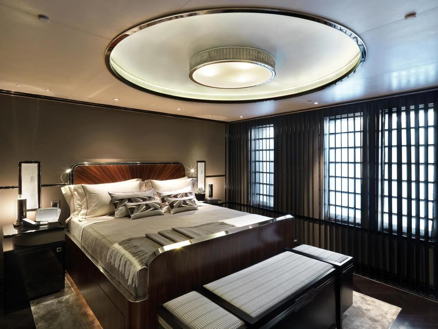 a room with a bed and a chandelier aboard SEALION Yacht for Sale