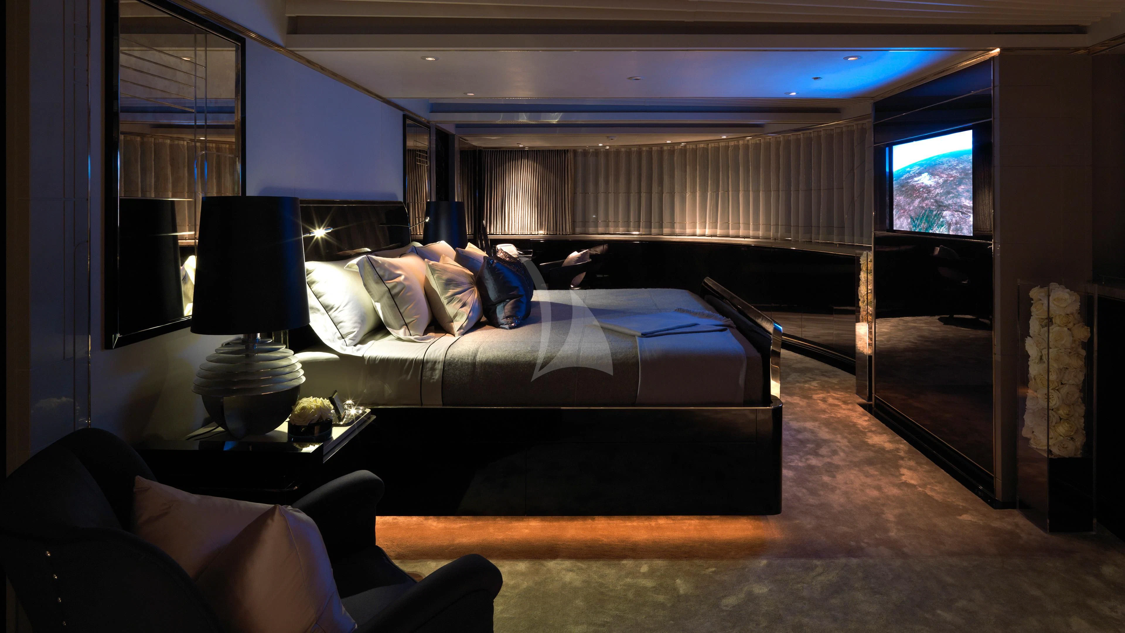 a bedroom with a bed and a desk aboard SEALION Yacht for Sale