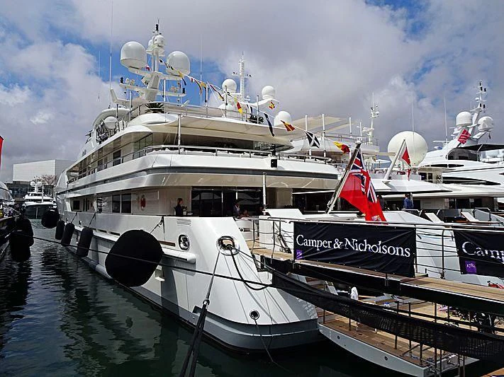 a large white boat with a red stripe on the front aboard SEALION Yacht for Sale