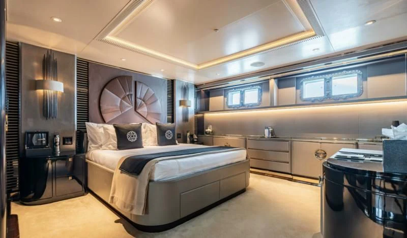 a bedroom with a bed and a desk aboard SEALION Yacht for Sale