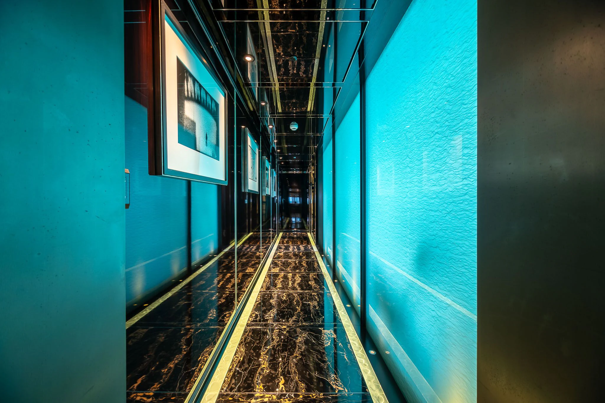 a hallway with a light blue wall aboard SEALION Yacht for Sale