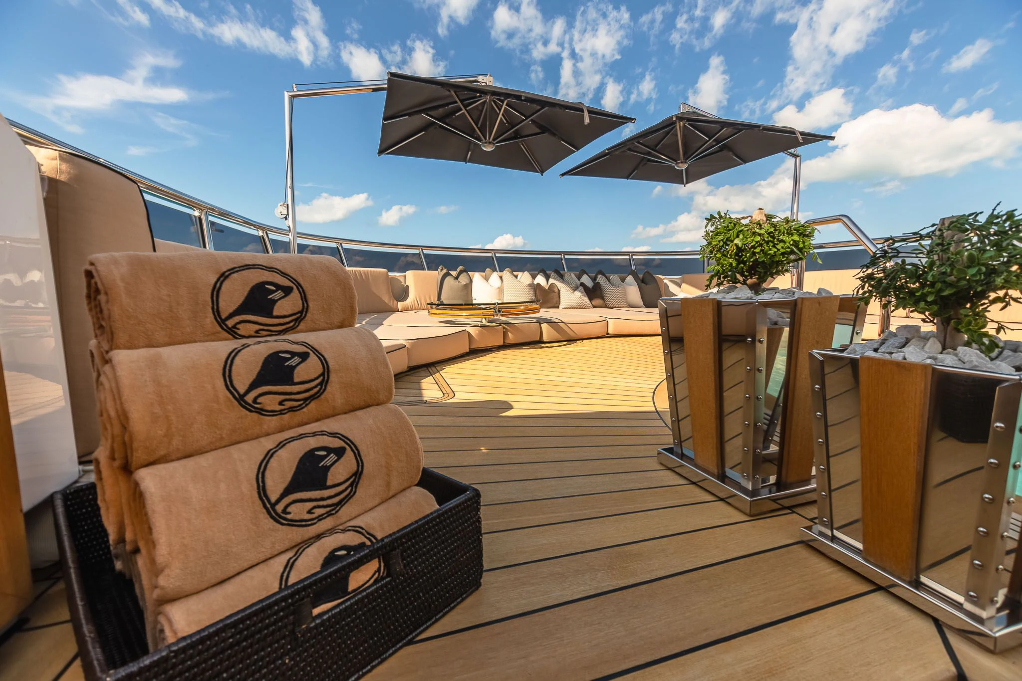 a deck with a wood deck and chairs and a large satellite dish on it aboard SEALION Yacht for Sale