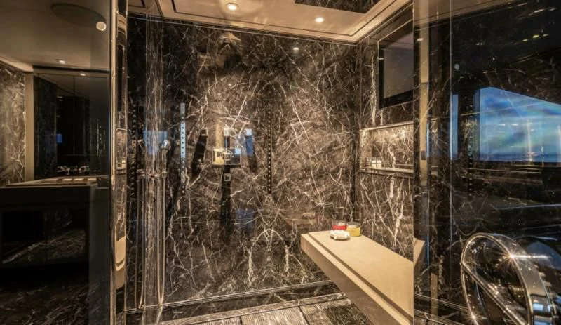 a room with a wall of glass and a table with objects on it aboard SEALION Yacht for Sale