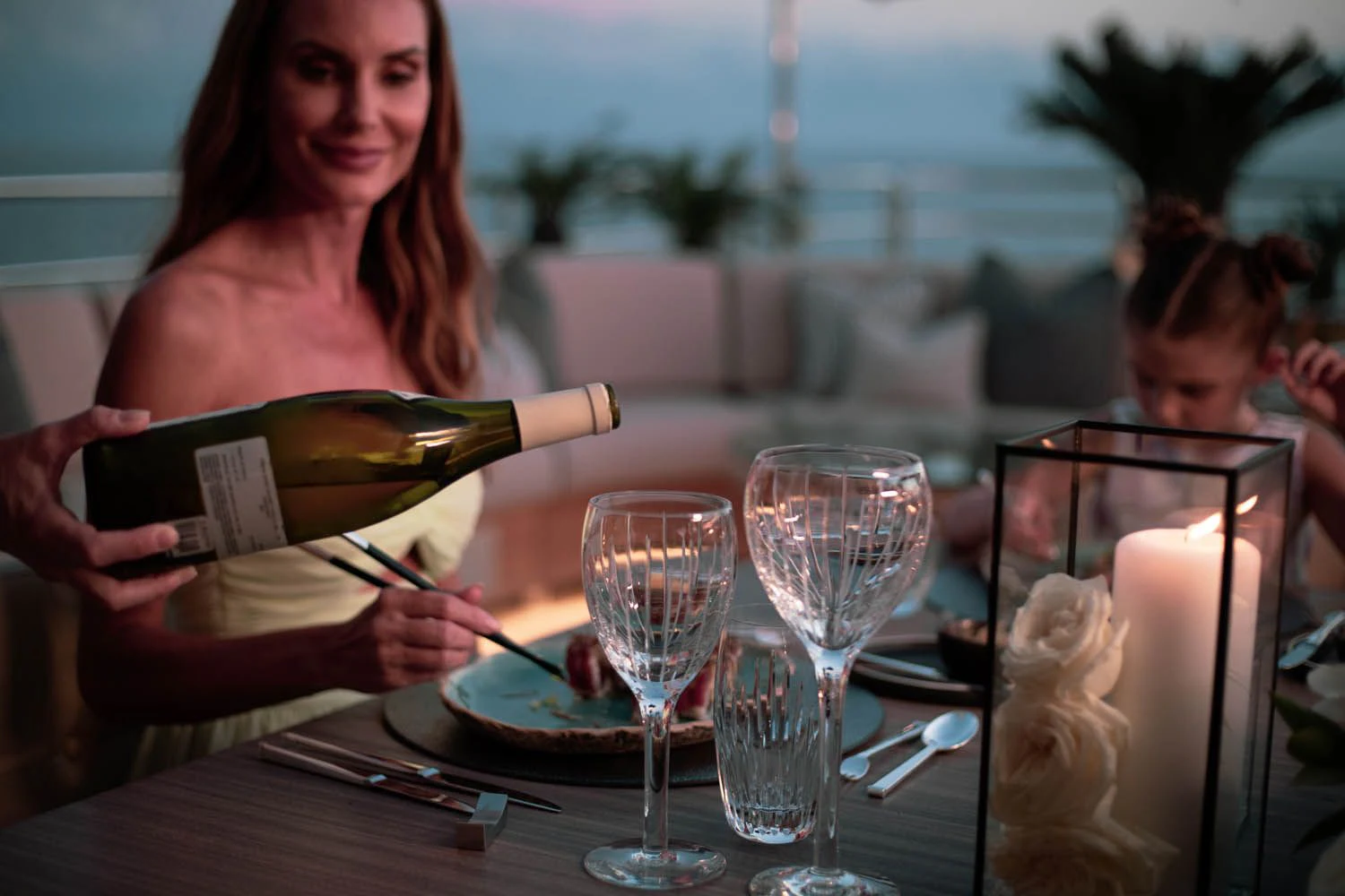 a woman reading a book to a group of people at a table aboard SEALION Yacht for Sale