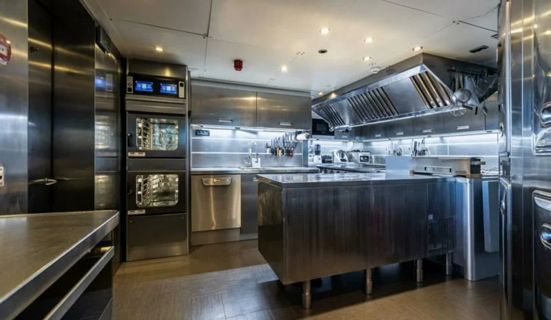 a large kitchen with stainless steel appliances aboard SEALION Yacht for Sale