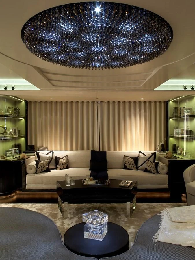 a living room with a chandelier aboard SEALION Yacht for Sale