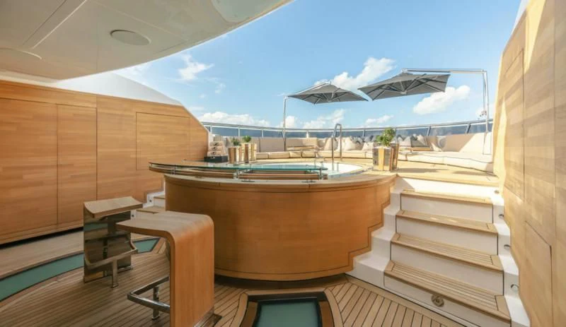 a room with a pool table and a view of the water aboard SEALION Yacht for Sale