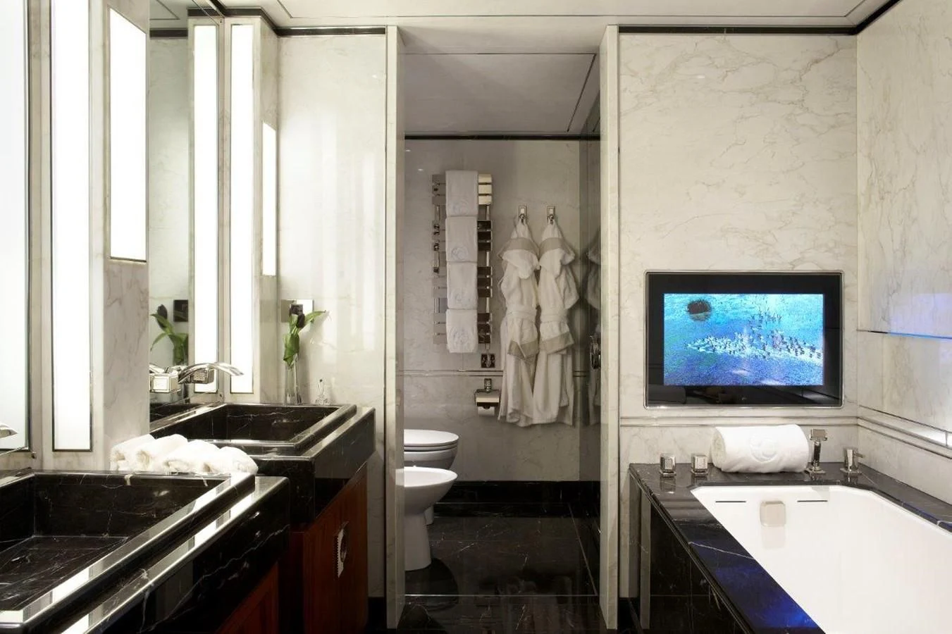 a bathroom with a tv on the wall aboard SEALION Yacht for Sale