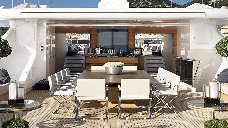 a kitchen with a table and chairs aboard SEALION Yacht for Sale