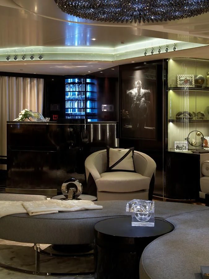 a room with a couch and a table and a fireplace aboard SEALION Yacht for Sale