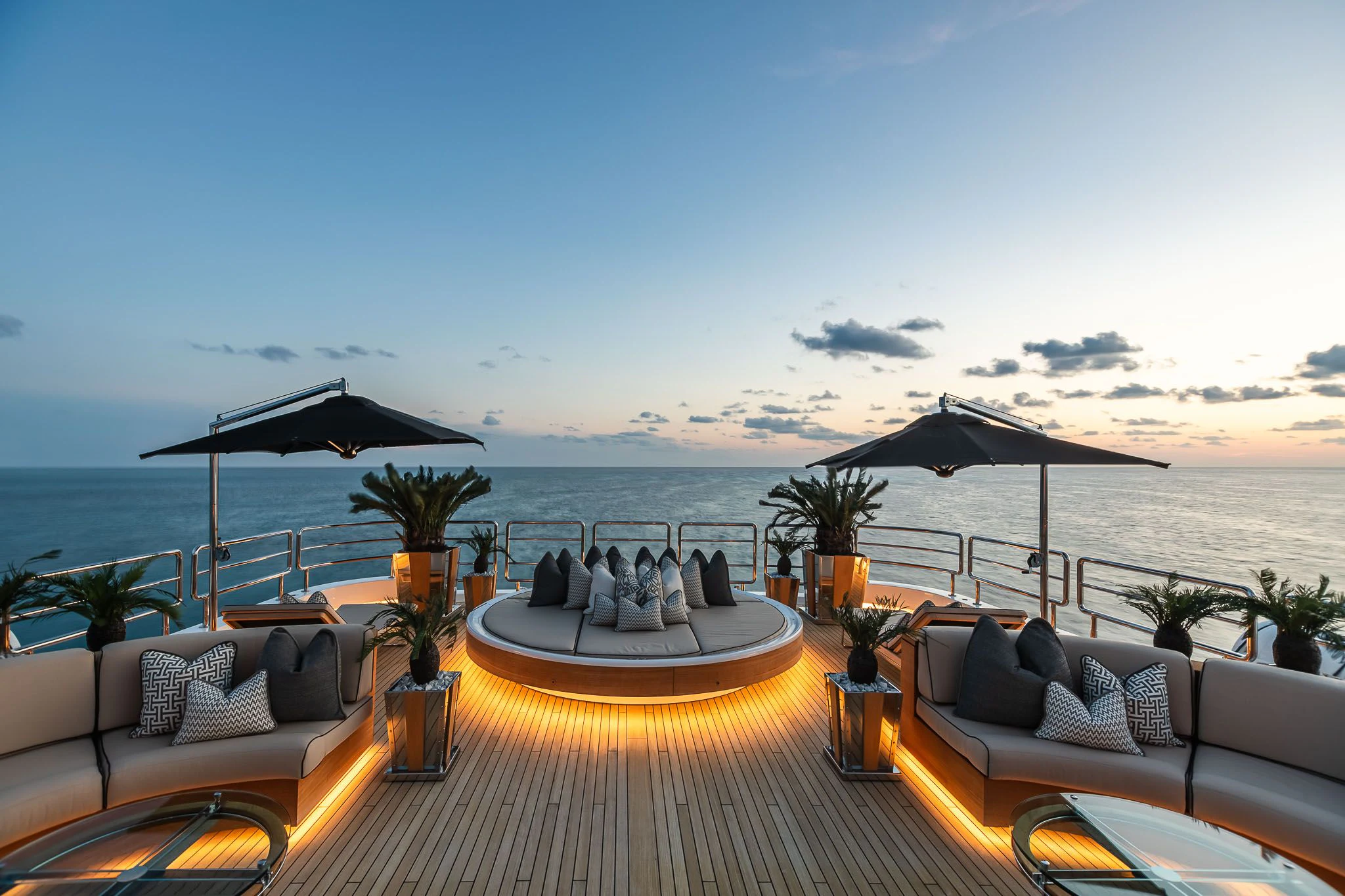 a patio with a table and chairs on it by the water aboard SEALION Yacht for Sale