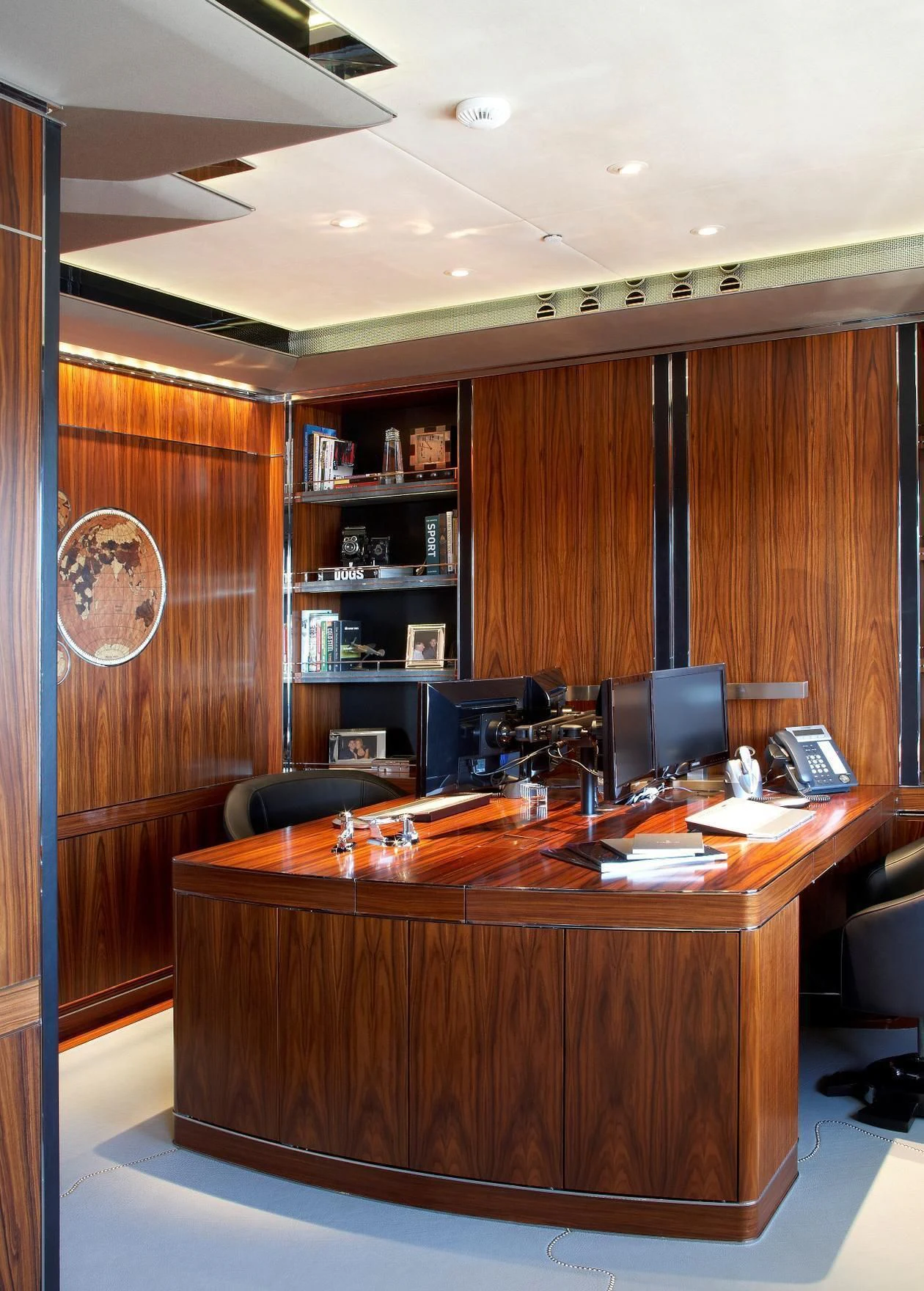 a desk with a computer and a bookcase aboard SEALION Yacht for Sale