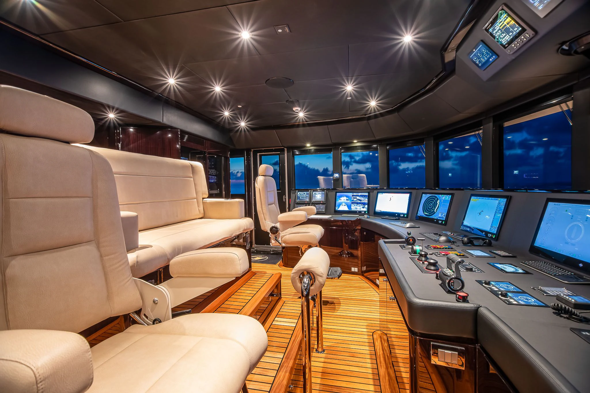 a room with many monitors and chairs aboard SEALION Yacht for Sale