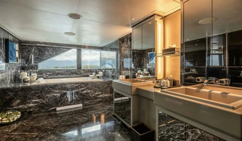 a bathroom with a large glass wall aboard SEALION Yacht for Sale