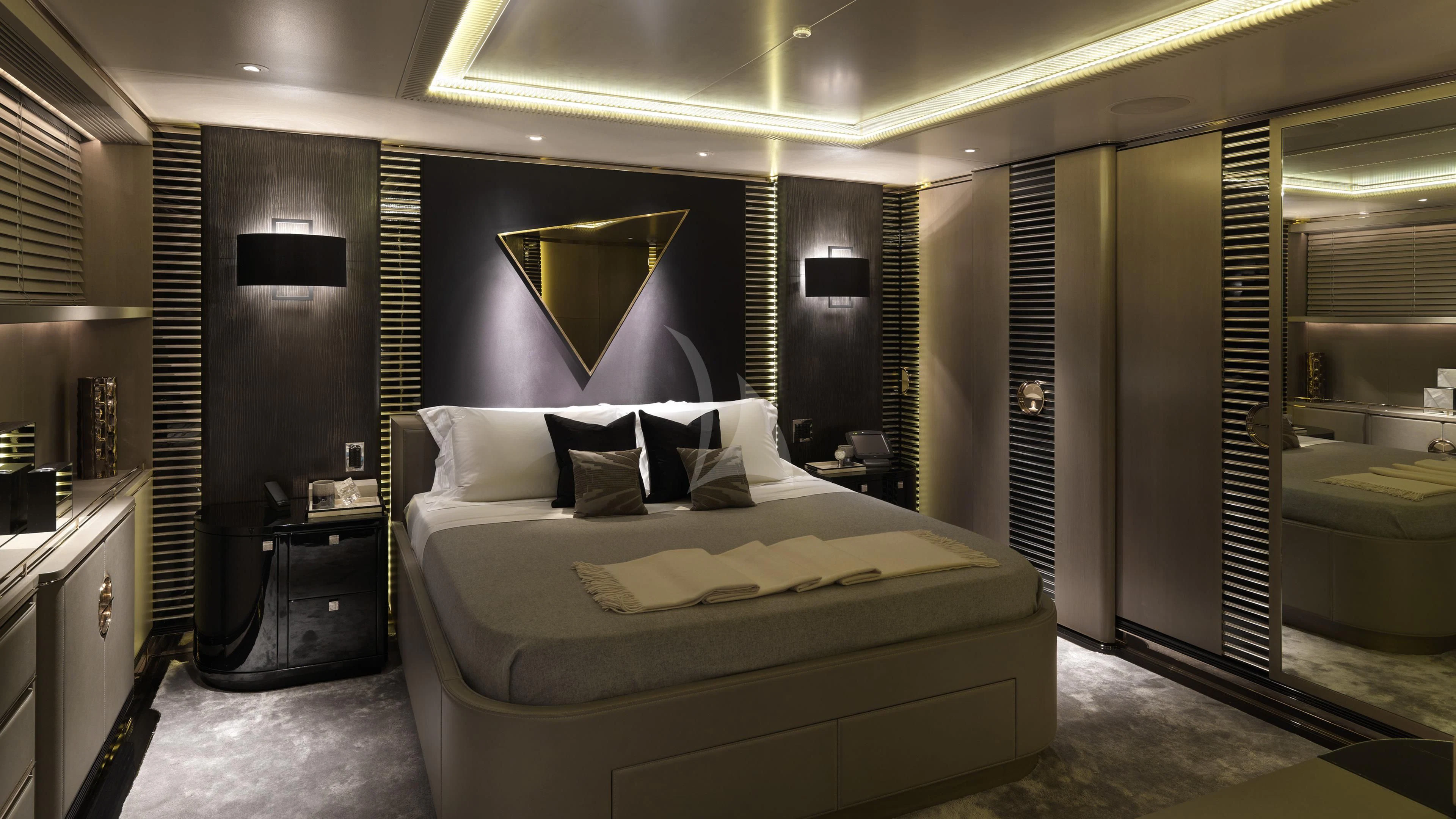 a room with a bed and a mirror aboard SEALION Yacht for Sale
