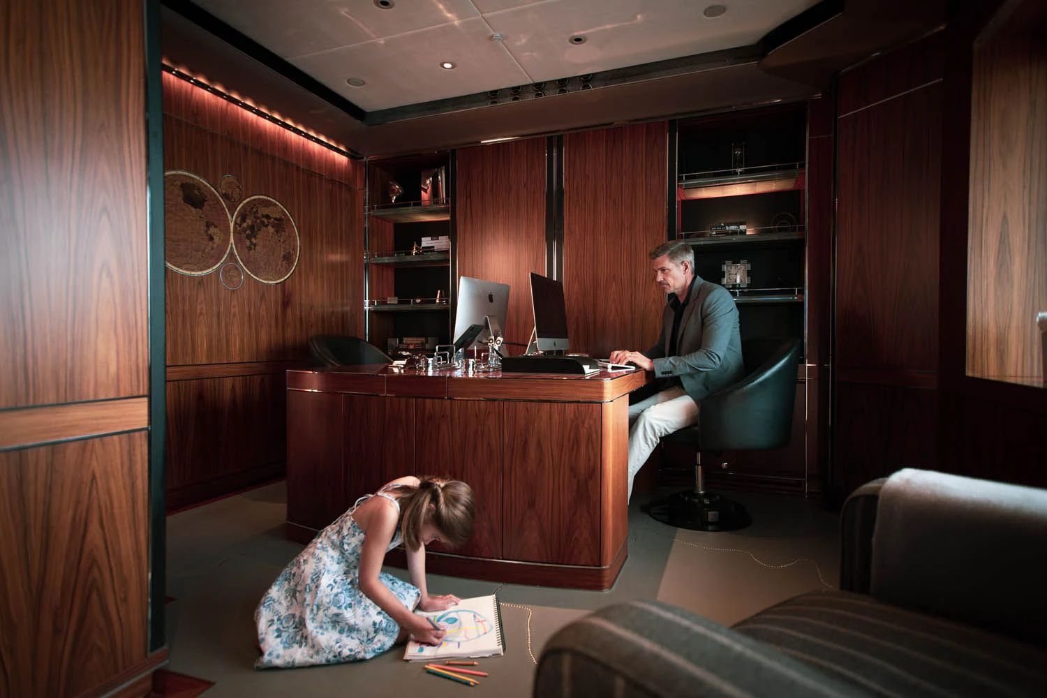 a man and a woman sitting at a table in a room aboard SEALION Yacht for Sale