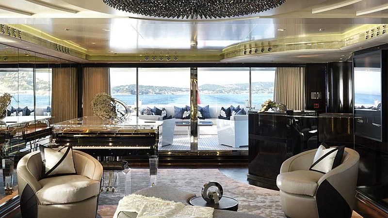 a room with a piano and a large window aboard SEALION Yacht for Sale