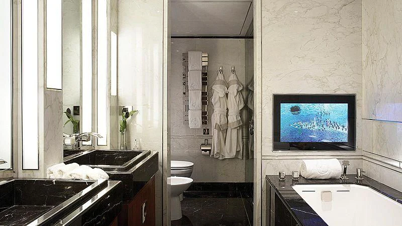 a bathroom with a tv on the wall aboard SEALION Yacht for Sale