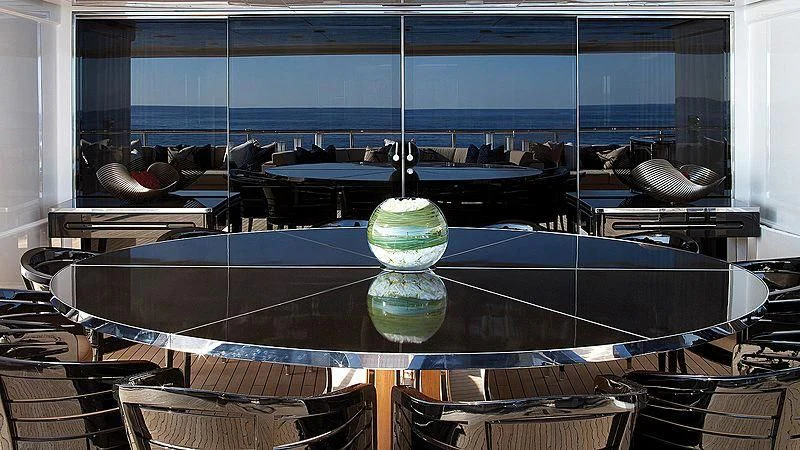 a pool with a large blue glass bowl on top aboard SEALION Yacht for Sale