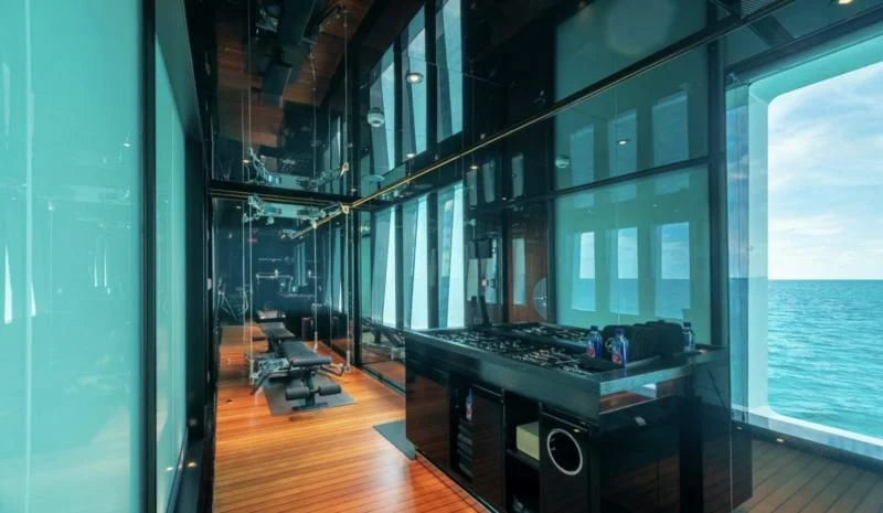 a room with a large window and a large piano aboard SEALION Yacht for Sale