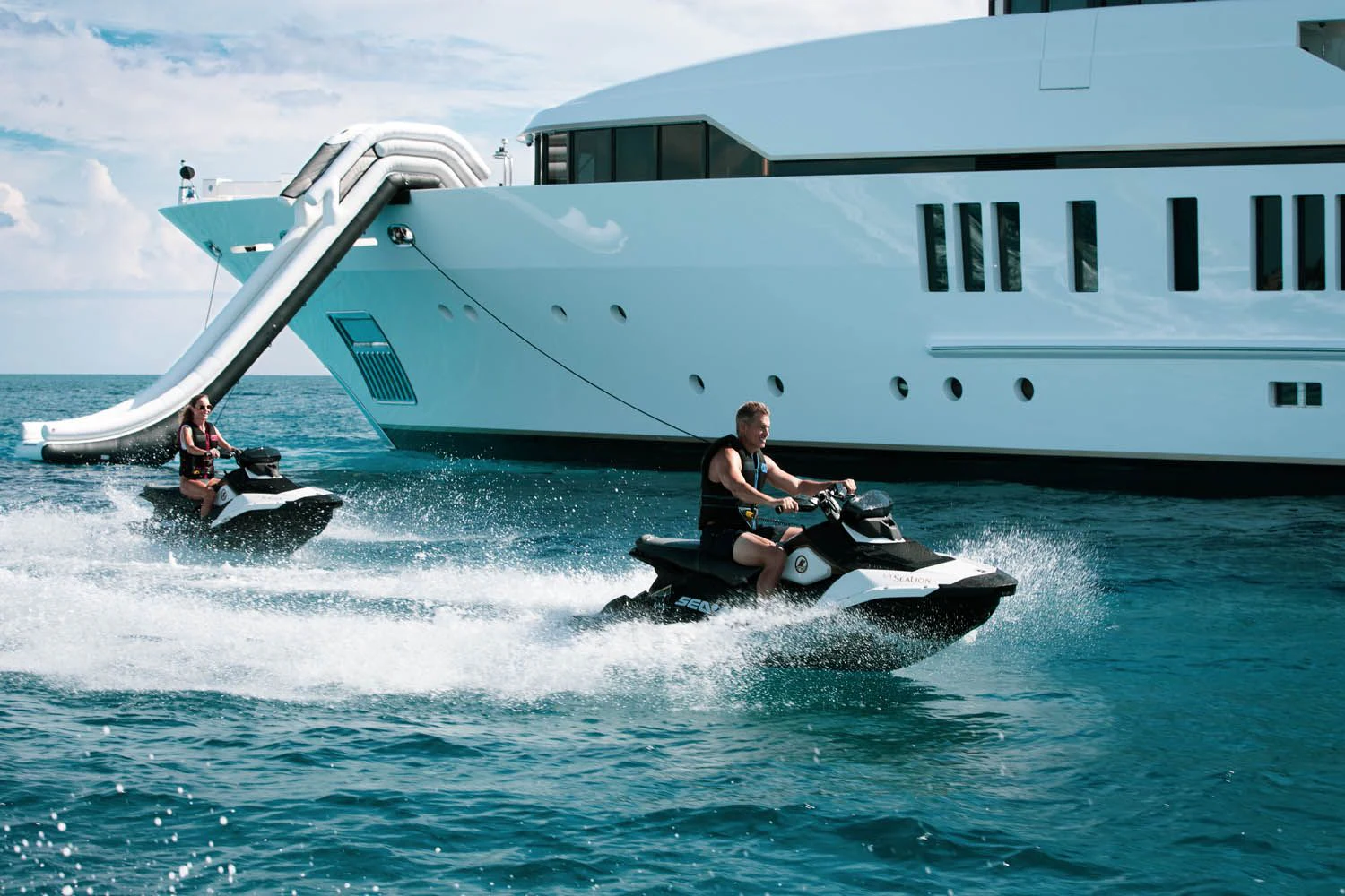 a couple of people on jet skis in the water aboard SEALION Yacht for Sale
