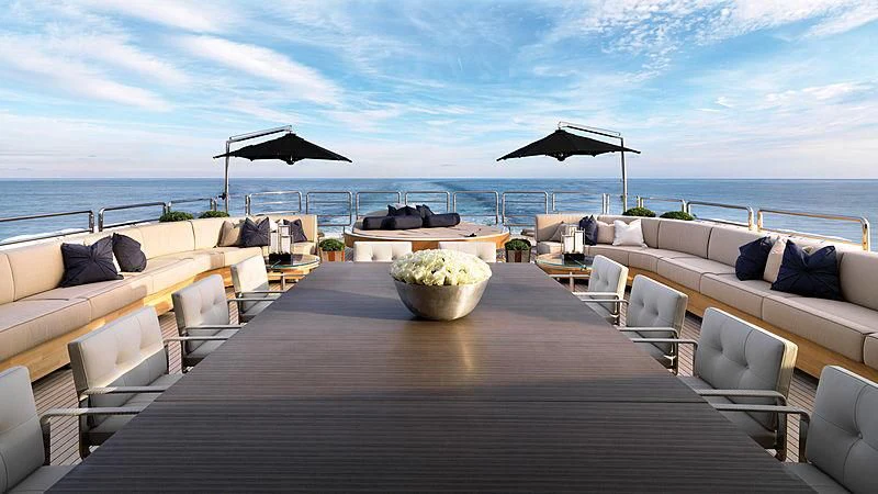 a deck with a large table and chairs on it aboard SEALION Yacht for Sale
